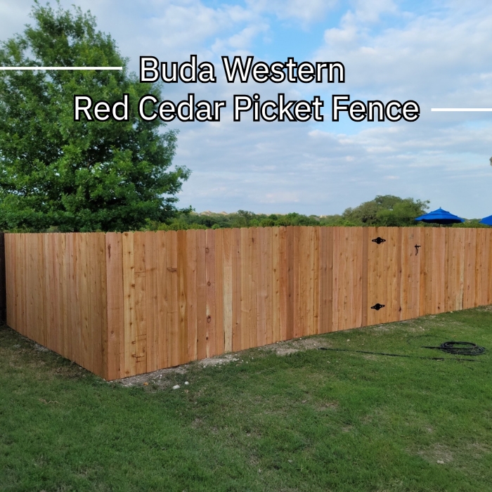 A close-up of a budawestern red cedar picket fence, showcasing its natural wood grain and vertical slats.