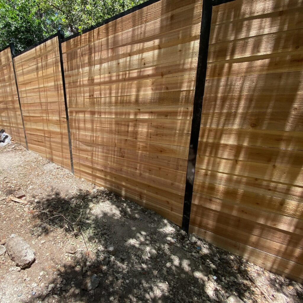 Contemporary horizontal picket fence adding privacy without sacrificing design.