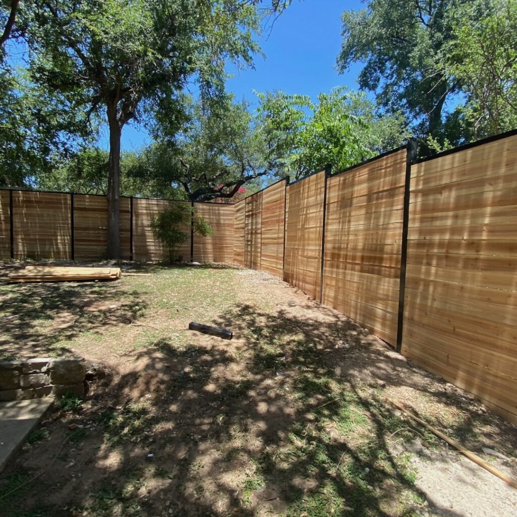 Quality horizontal fence build with evenly spaced wooden slats for airflow and style.
