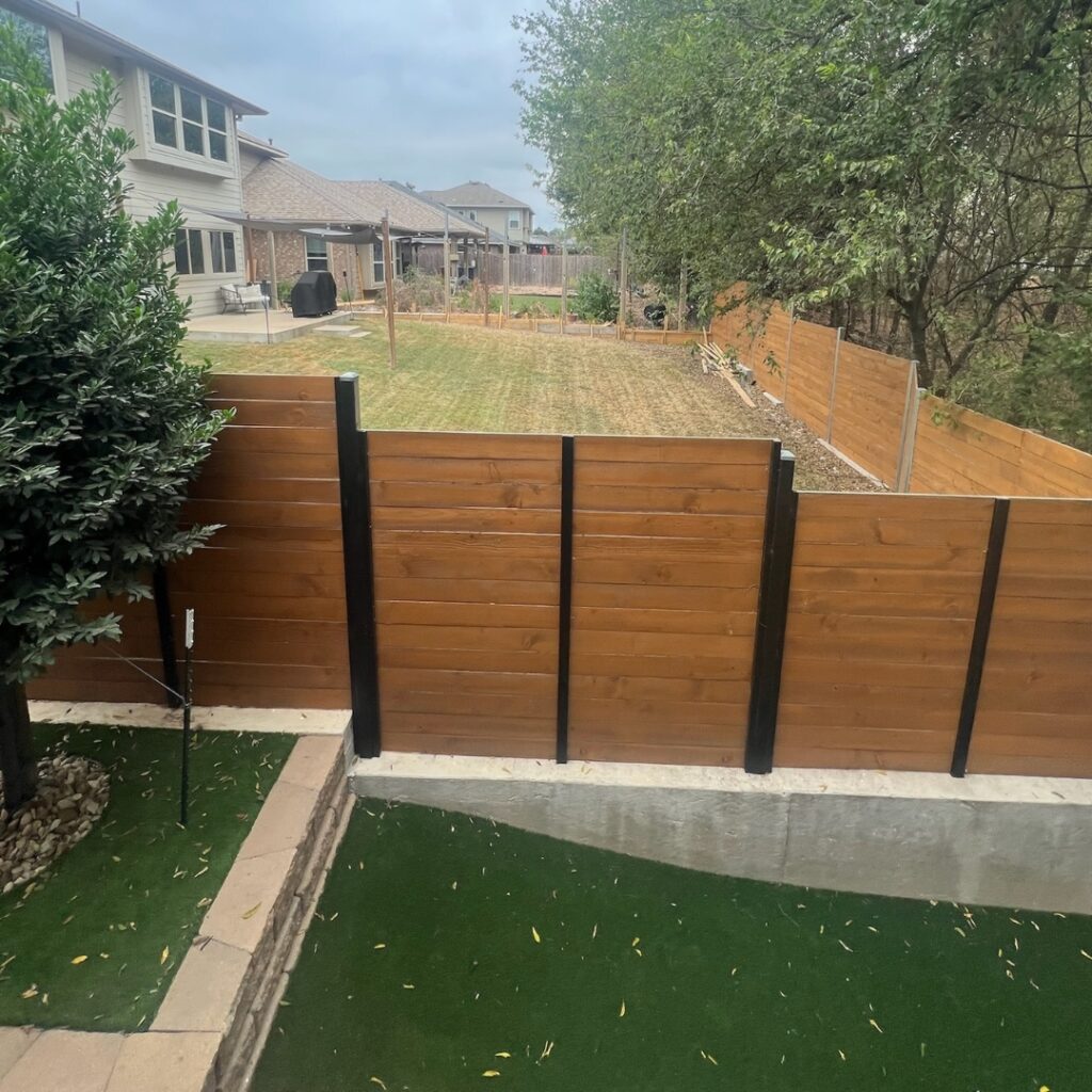 Custom horizontal slat fence offering a contemporary look for a residential yard in Austin.