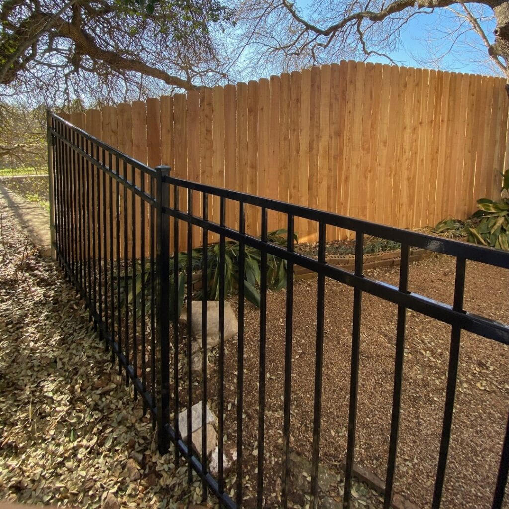 Austin home with black ornamental fence offering timeless design and curb appeal.