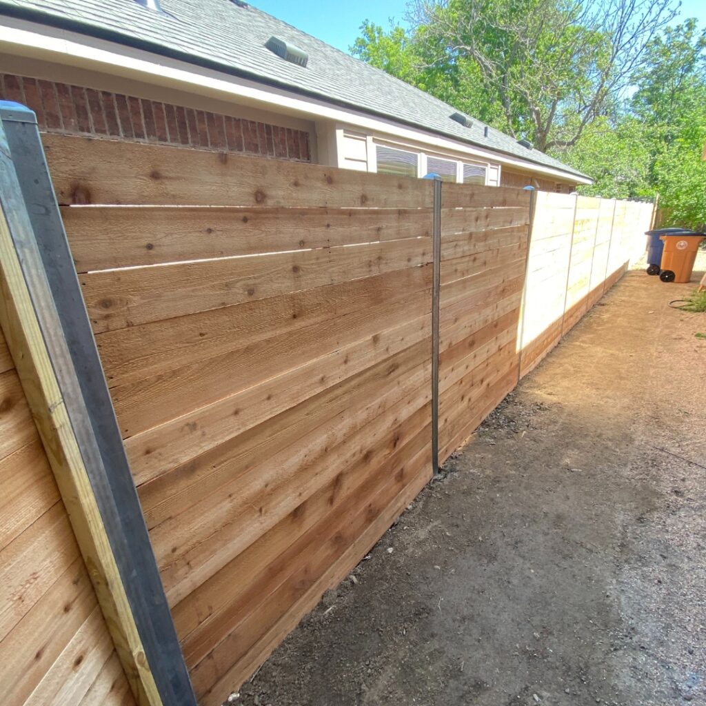 Wooden horizontal picket fence combining privacy with a minimalist design.