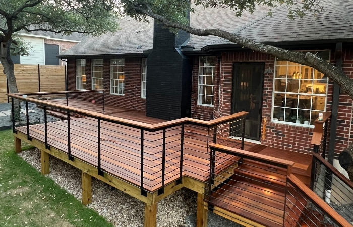 IPE wood deck with horizontal steel balustrade railing, artificial turf, and horizontal cedar privacy fence