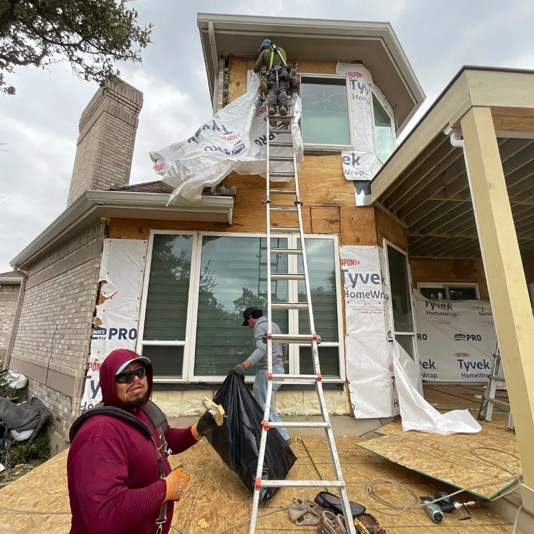Installation of Hardie siding underway on exterior wall with partial coverage