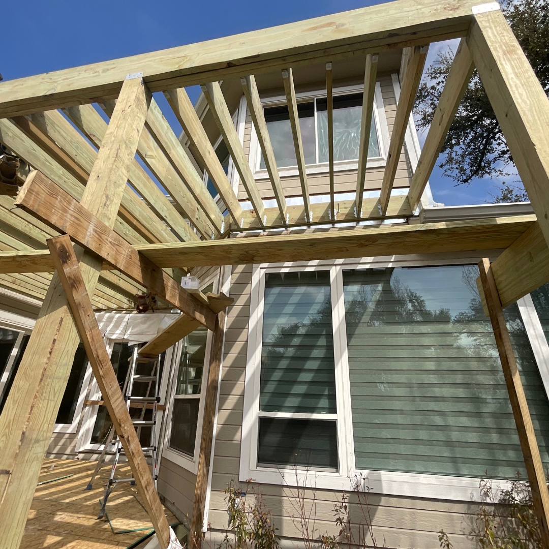 Framing stage of TimberTech Tigerwood deck with exposed joists and support beams