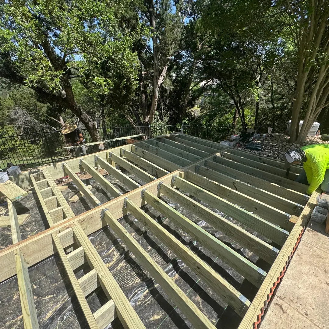 Framing underway for French White Oak PVC deck with pressure-treated lumber