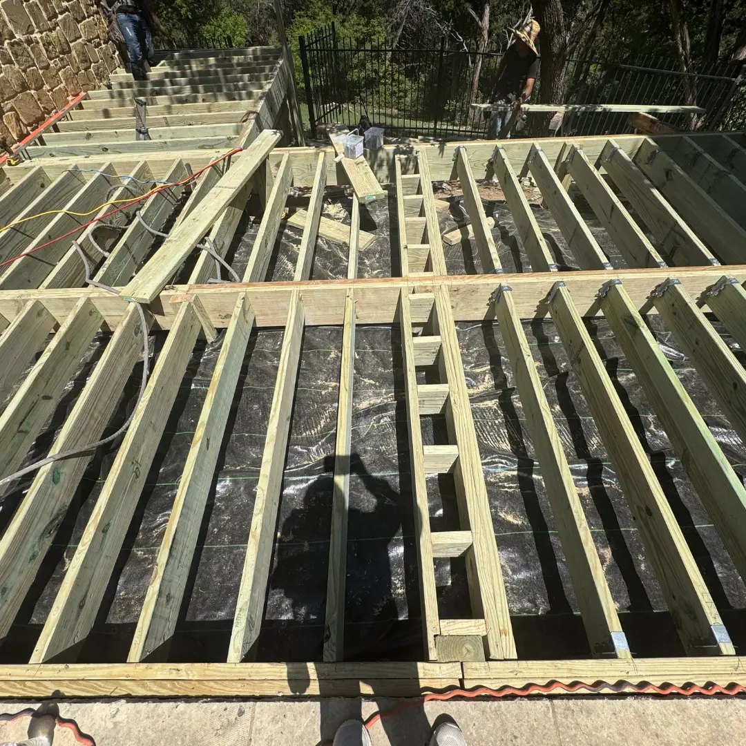 Framing underway for French White Oak PVC deck with pressure-treated lumber