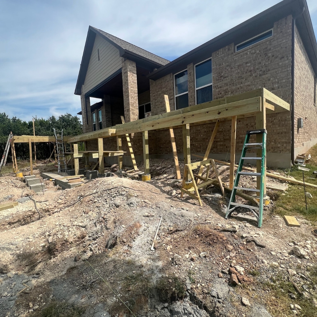 Construction in progress for Trex Toasted Sand deck with framing and cable railing posts being installed