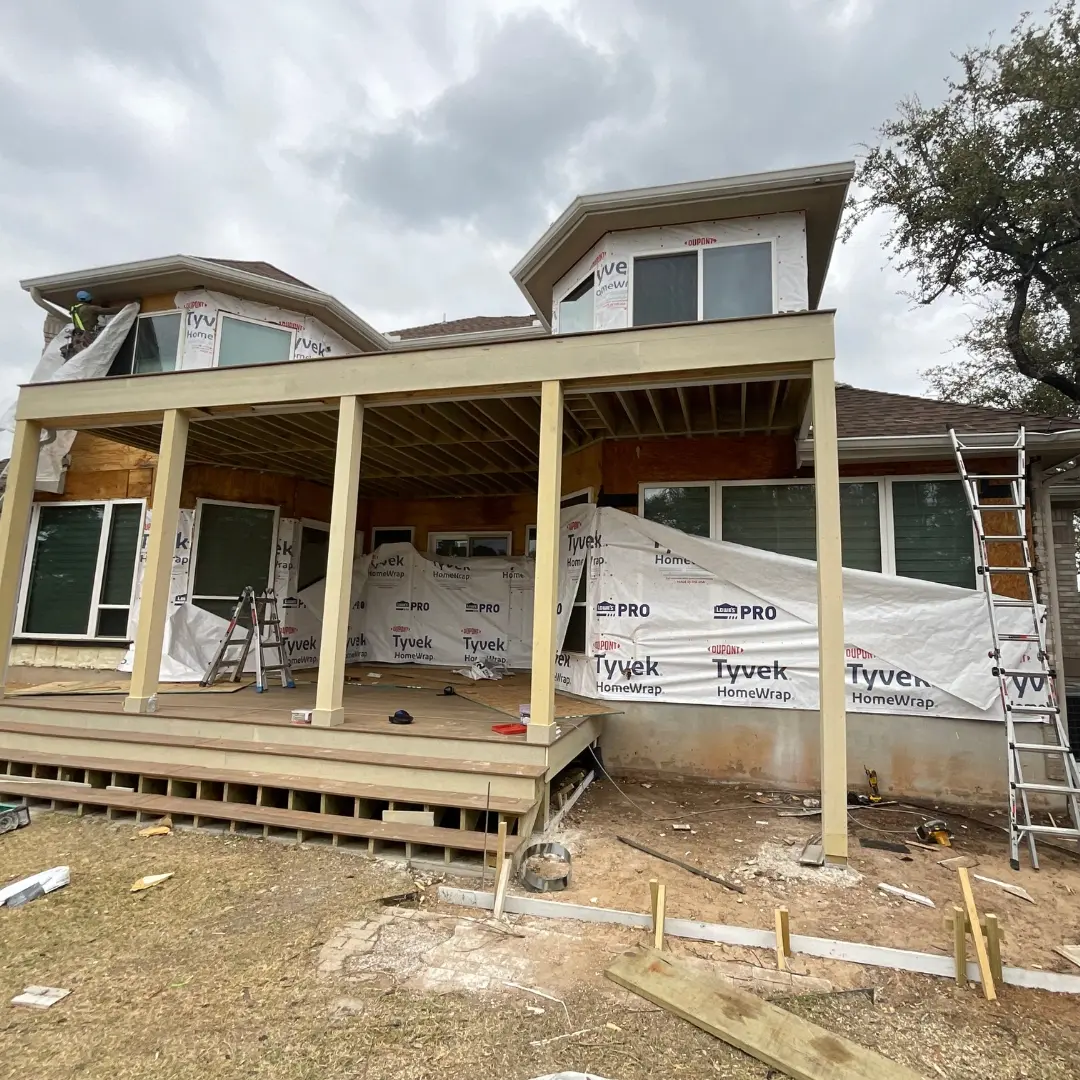 Framing stage of TimberTech Tigerwood deck with exposed joists and support beams