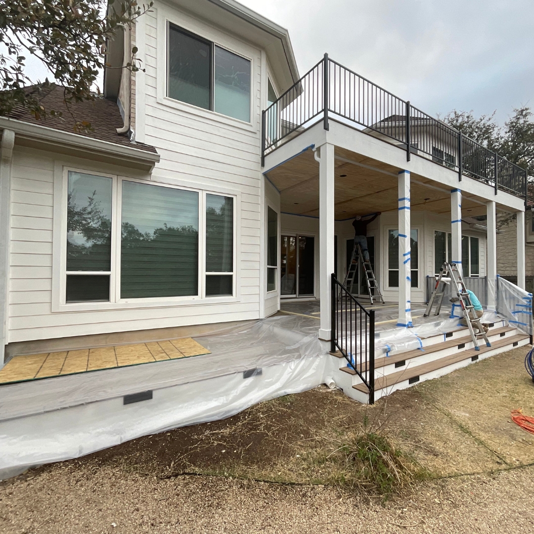 Project mid-build showing integration of multiple elements: deck framing, skirting, and outdoor kitchen base