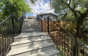 Custom residential deck installation with composite material and ornamental railing.