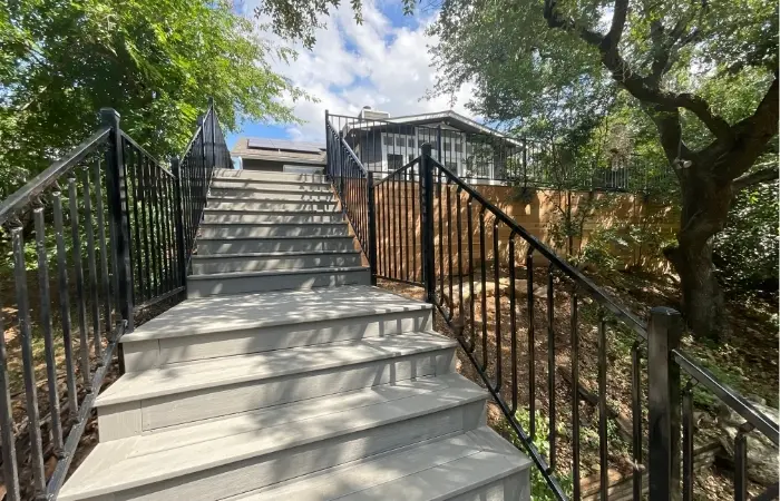 Custom residential deck installation with composite material and ornamental railing.