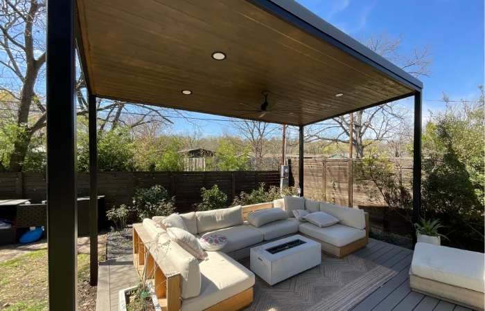 Mild steel patio cover with stained cedar soffit, finished in Tricorn Black DTM paint, featuring integrated electrical work