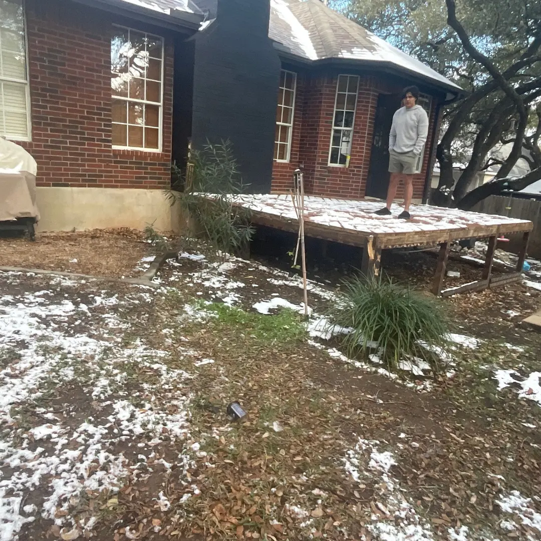 Before installation – bare backyard area with no deck, railing, turf, or fencing.