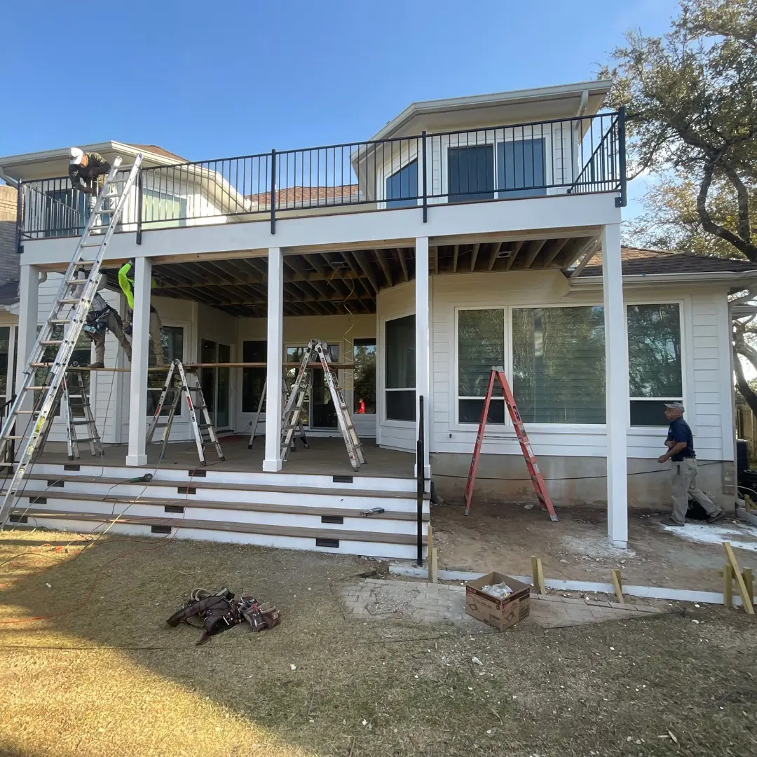 Project mid-build showing integration of multiple elements: deck framing, skirting, and outdoor kitchen base
