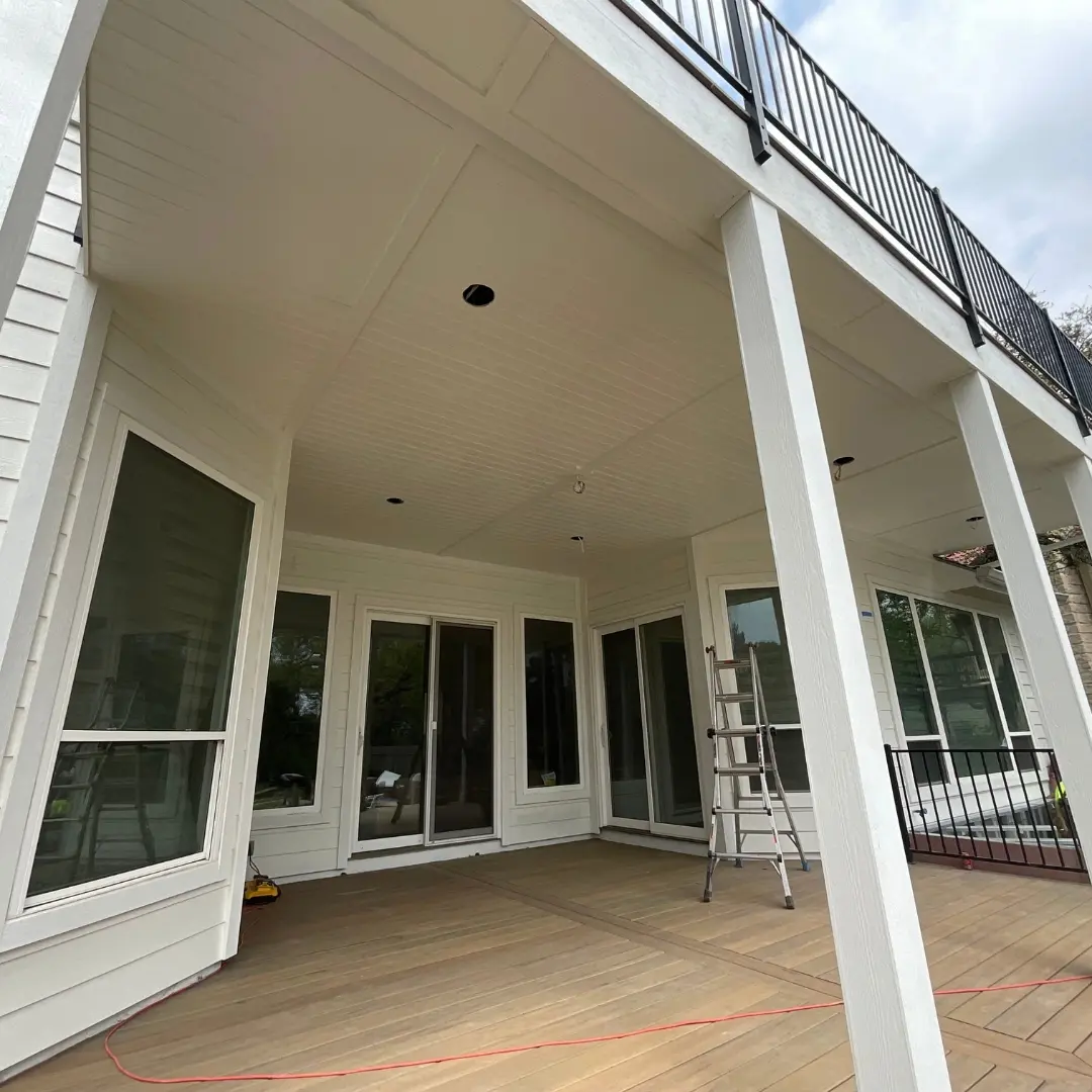 Project mid-build showing integration of multiple elements: deck framing, skirting, and outdoor kitchen base