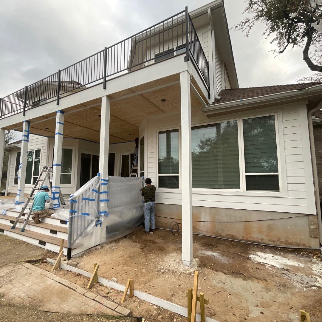 Project mid-build showing integration of multiple elements: deck framing, skirting, and outdoor kitchen base