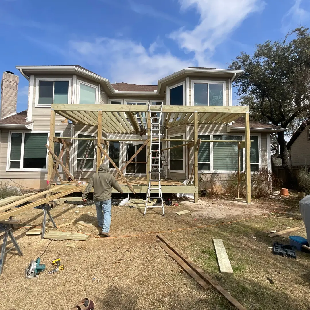 Project mid-build showing integration of multiple elements: deck framing, skirting, and outdoor kitchen base