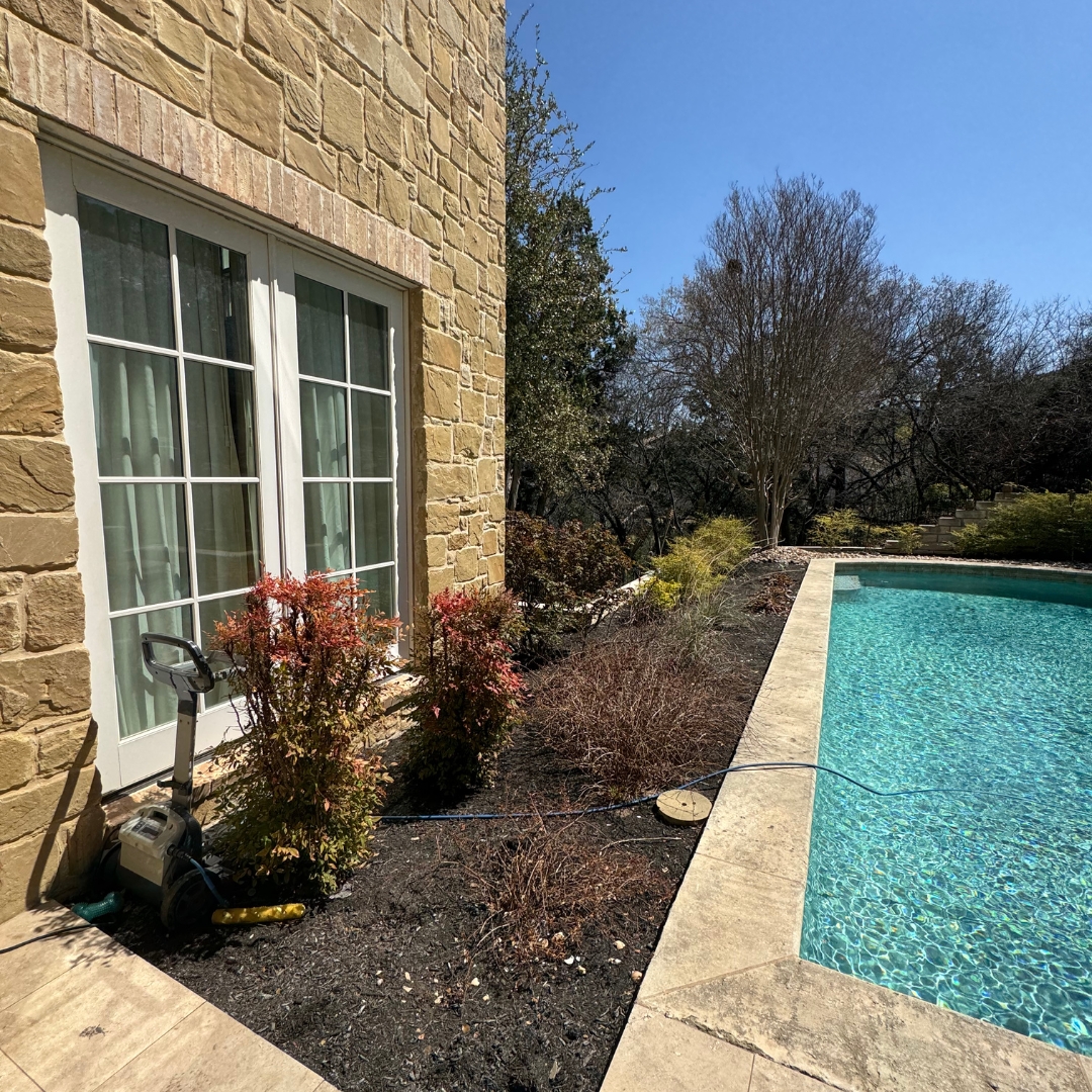 Backyard area before deck installation with bare ground and no defined structure