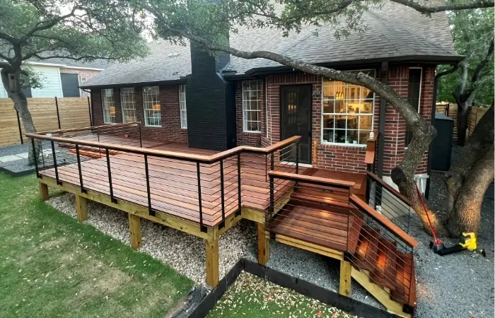 IPE wood deck with horizontal steel balustrade railing, artificial turf, and horizontal cedar privacy fence