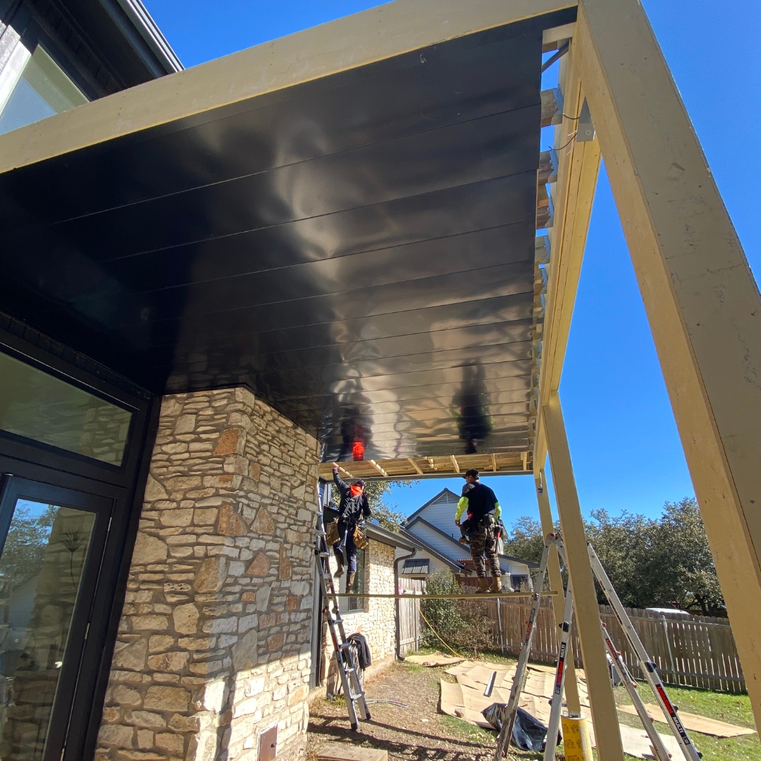 Ongoing installation of composite decking, metal soffit, and gutter system
