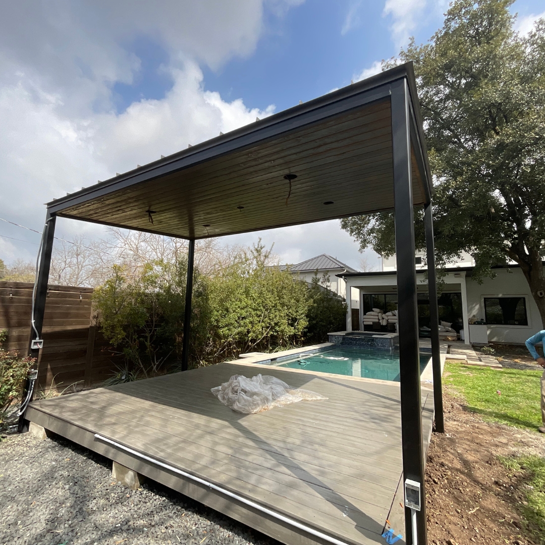 Construction of Mild steel patio cover with stained cedar soffit and Tricorn Black DTM paint finish