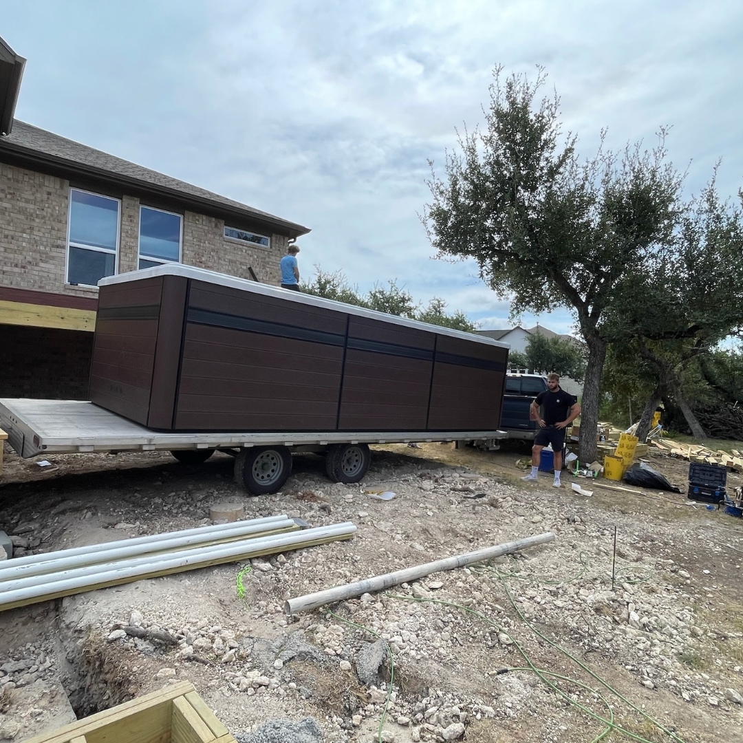 Construction in progress for Trex Toasted Sand deck with framing and cable railing posts being installed