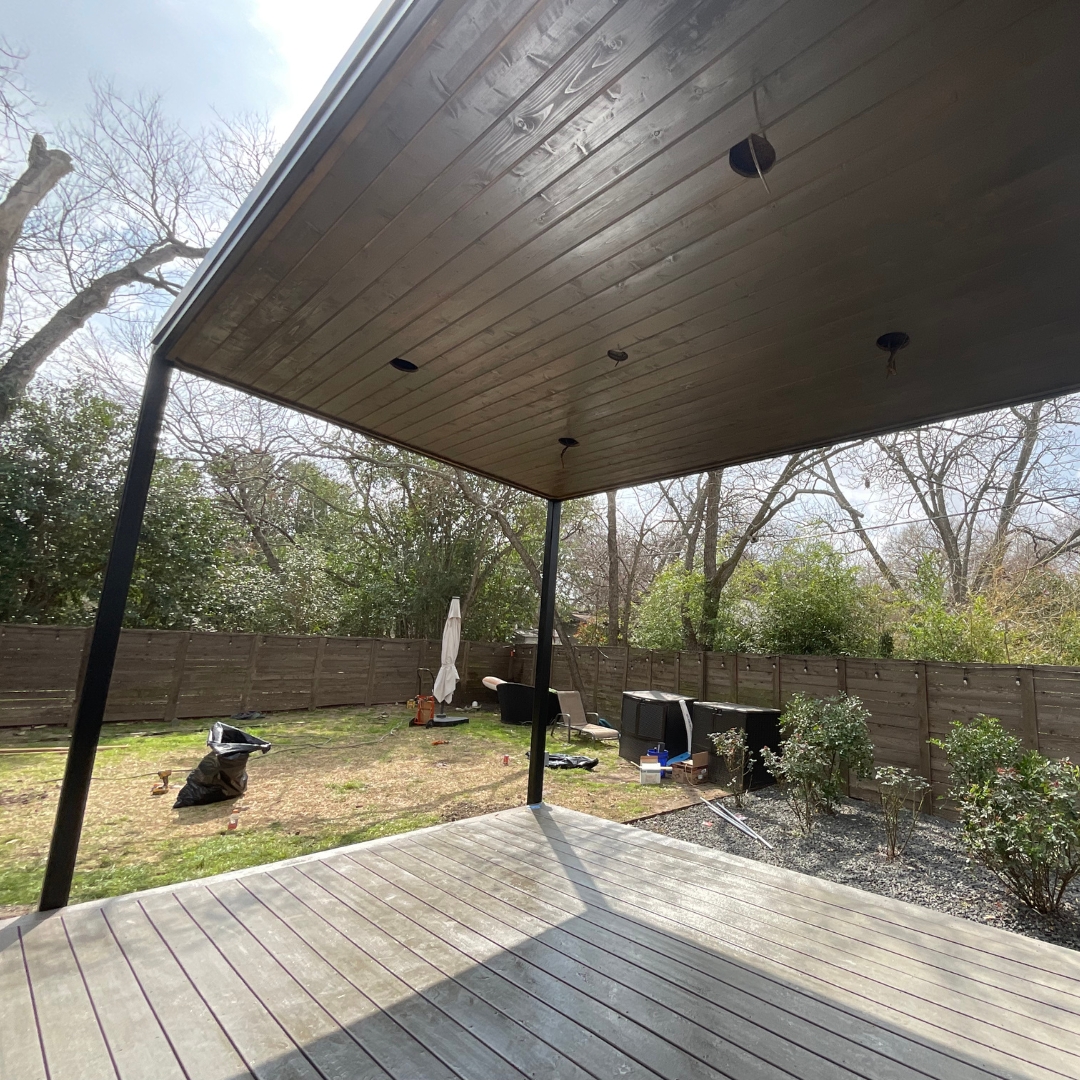 Construction of Mild steel patio cover with stained cedar soffit and Tricorn Black DTM paint finish