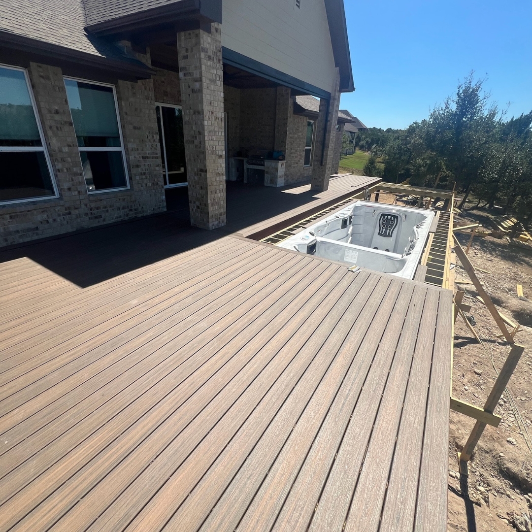 Construction in progress for Trex Toasted Sand deck with framing and cable railing posts being installed