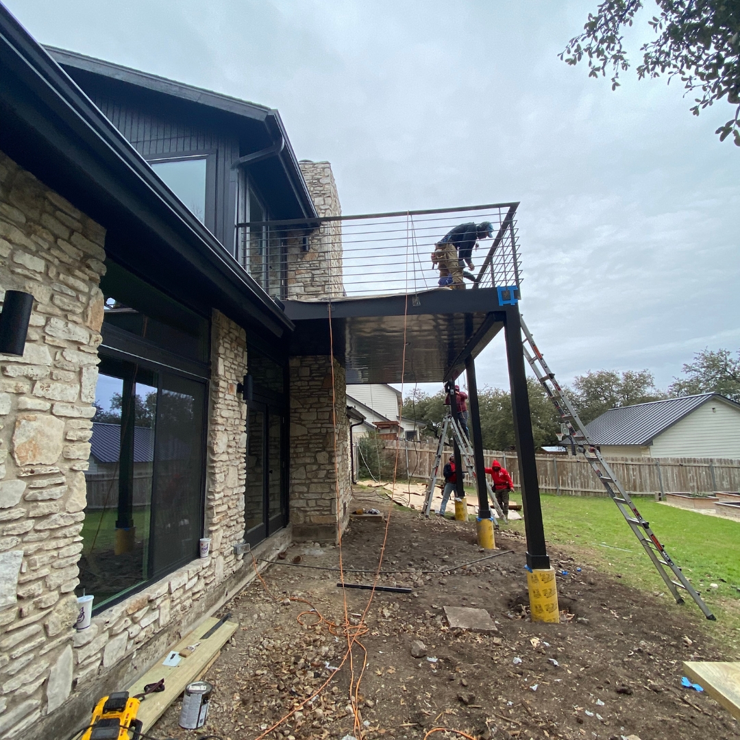 "Construction in progress for TimberTech French White Oak deck with framing and railing installation underway