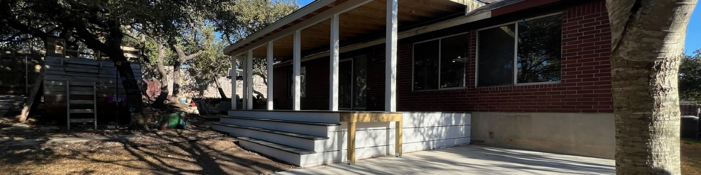 Completed Trex Basics deck with staircase and shingled patio cover.