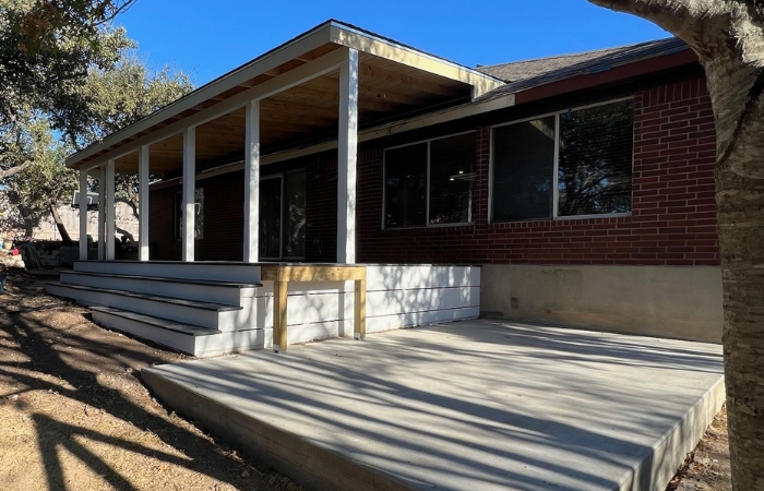 Finished outdoor space featuring composite deck and roofed patio cover.