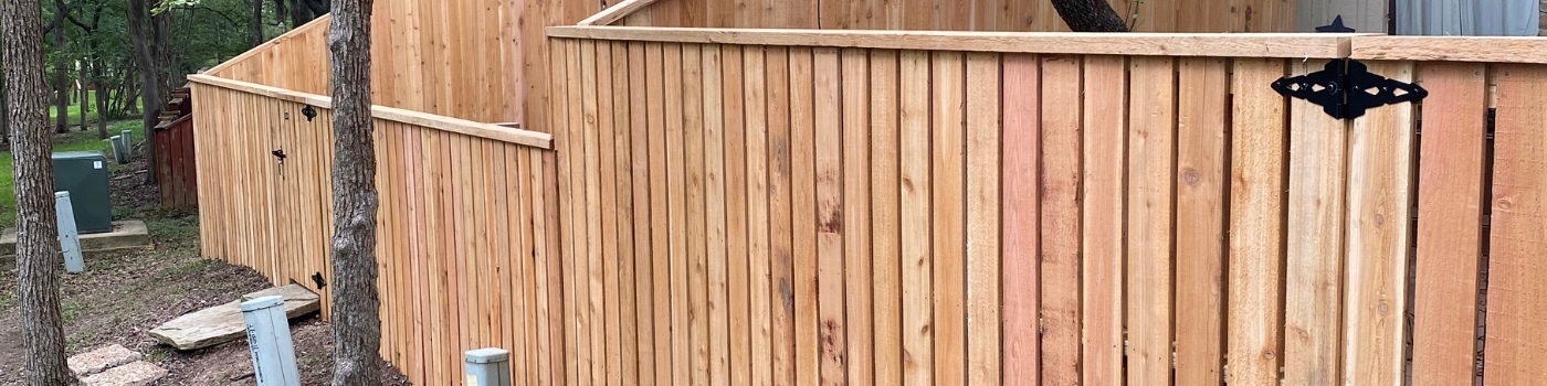 Completed Western Red Cedar shadowbox fence with matching gate and 4x4 pressure-treated posts.
