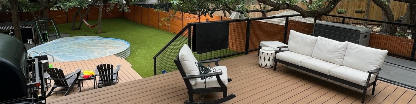 Two-level Trex Saddle Brown composite deck with custom bull panel steel railing and artificial turf inset.