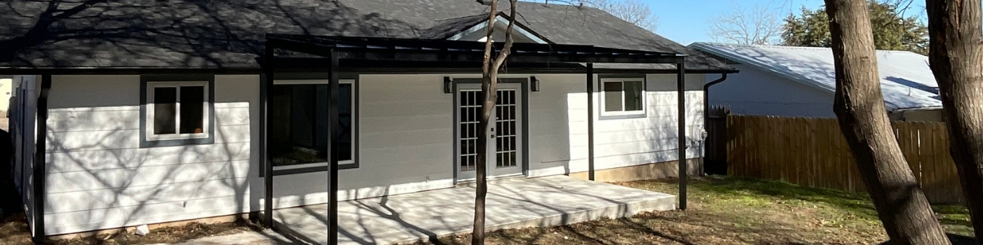 Steel patio cover with sleek standing seam metal roof in matte black finish