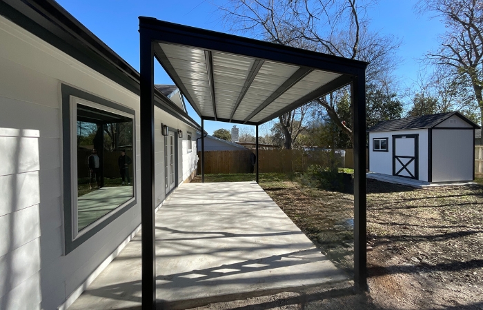 Steel patio cover with sleek standing seam metal roof in matte black finish