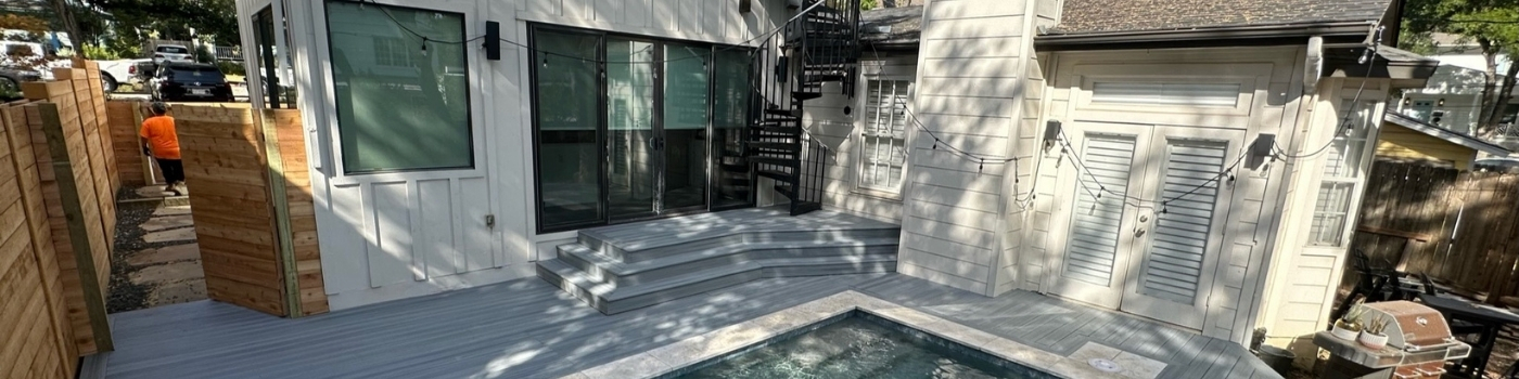 Trex Rocky Harbor composite deck with sleek horizontal cedar skirting and custom metal spiral staircase.