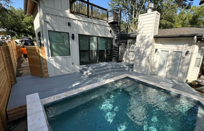 Trex Rocky Harbor composite deck with sleek horizontal cedar skirting and custom metal spiral staircase.