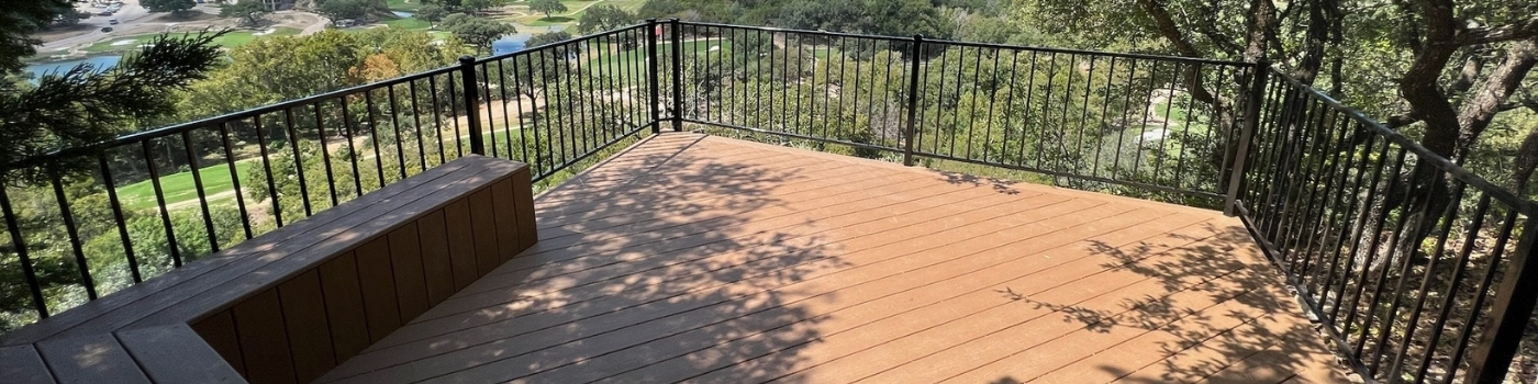 Side angle of one of the finished decks showing clean lines, rich composite color, and modern railing.
