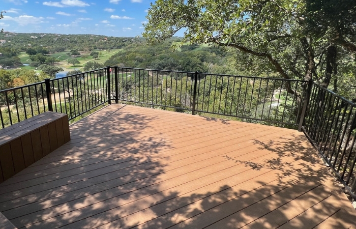 Side angle of one of the finished decks showing clean lines, rich composite color, and modern railing.