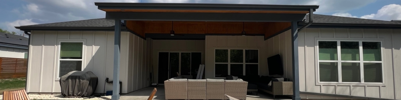 Completed lean-to patio cover with T1-11 soffit ceiling and clean Hardie board wrap.