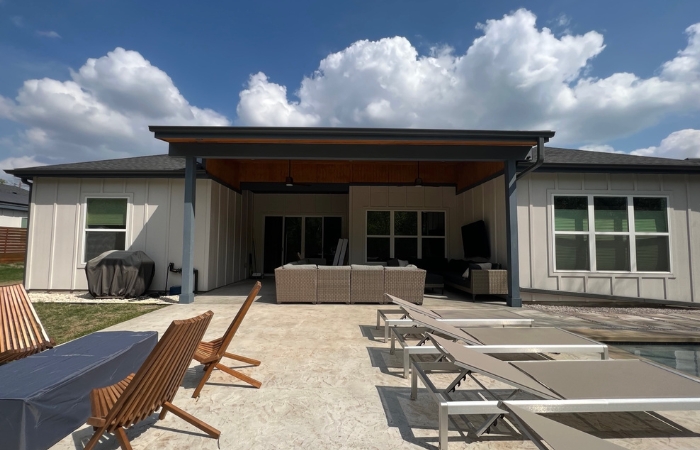 Completed lean-to patio cover with T1-11 soffit ceiling and clean Hardie board wrap.