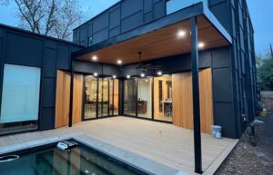 After photo of a sleek steel frame patio cover with a standing seam metal roof, providing shade and style.