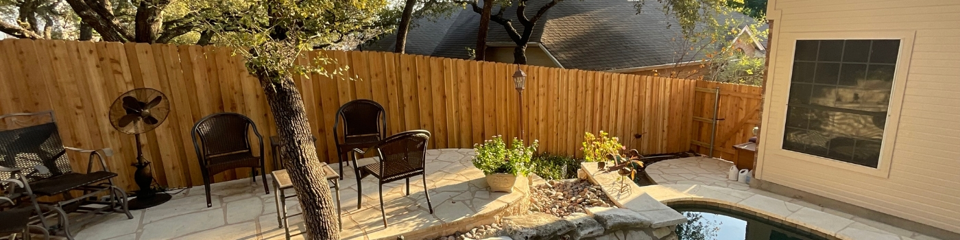 Newly installed Western Red Cedar vertical picket fence with staggered metal posts.