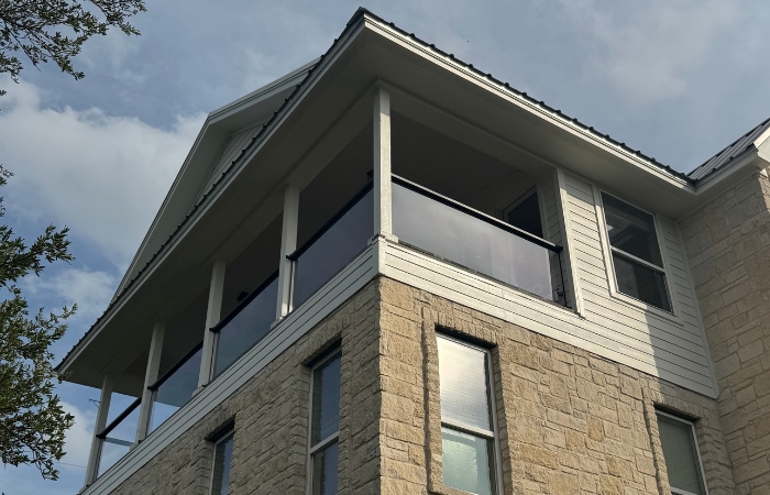 Residential deck featuring a completed clear plexiglass guardrail that maintains open views.