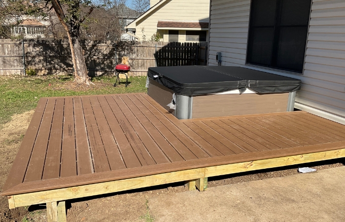 Close-up of Trex Beach Dune deck boards surrounding hot tub edge