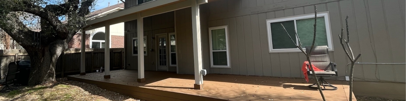 Completed Trex Saddle Brown deck with attached lean-to patio cover and wood soffit.