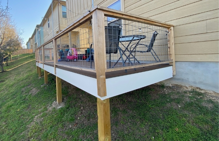 Completed Trex Saddle Brown deck with full cedar bull panel railing installed.