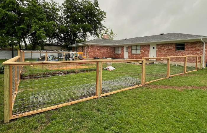Completed bull panel railing with pressure-treated pine posts.