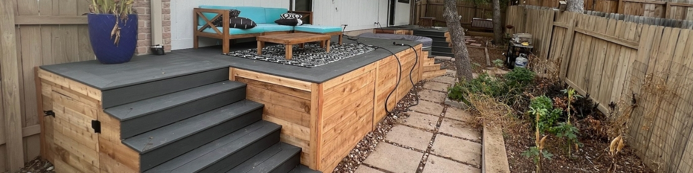 Backyard view of finished twin composite decks surrounding a cowboy pool.